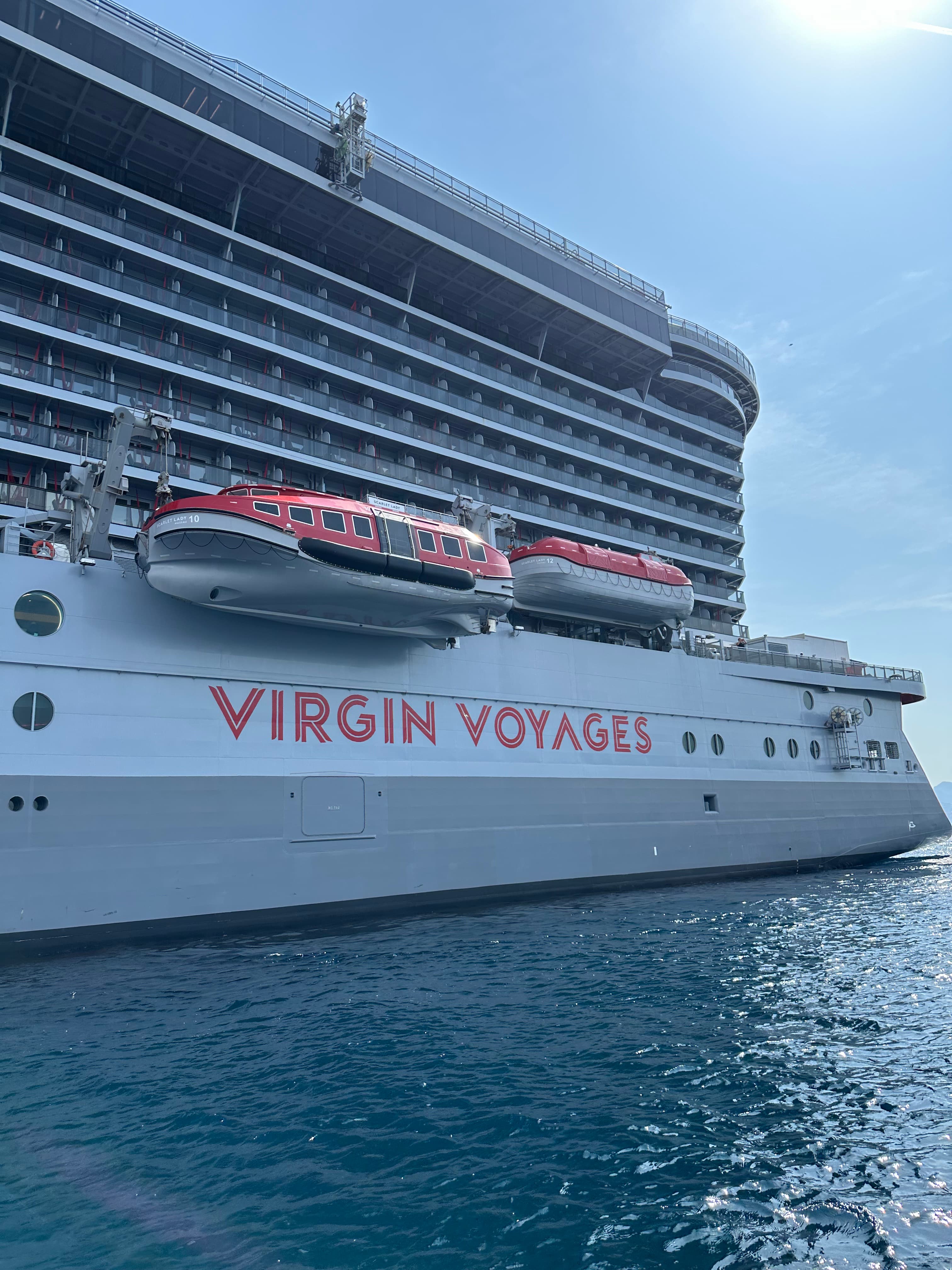 VIRGIN VOYAGES Schriftzug am Rumpf mit roten Rettungsbooten